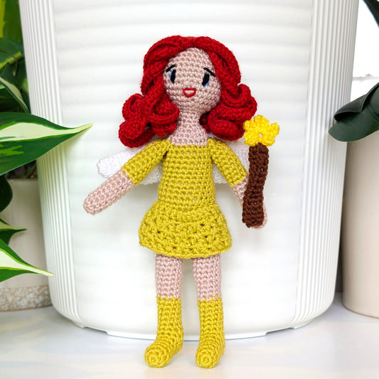 Crocheted doll with red hair and chartreuse yellow dress