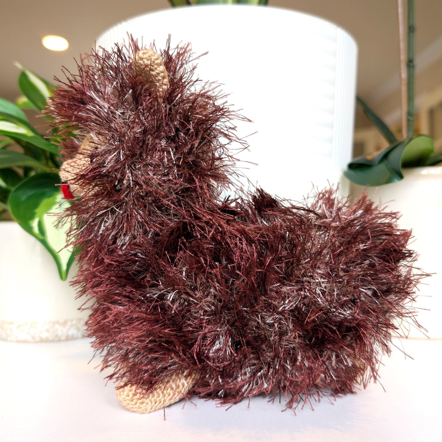 Side view of crocheted fluffy Pomeranian dog with burgundy and silver coat