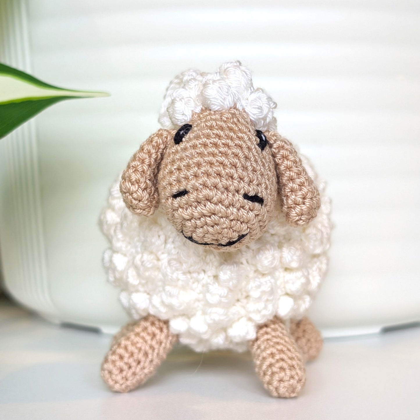 Front view of crocheted sheep plush with beige body