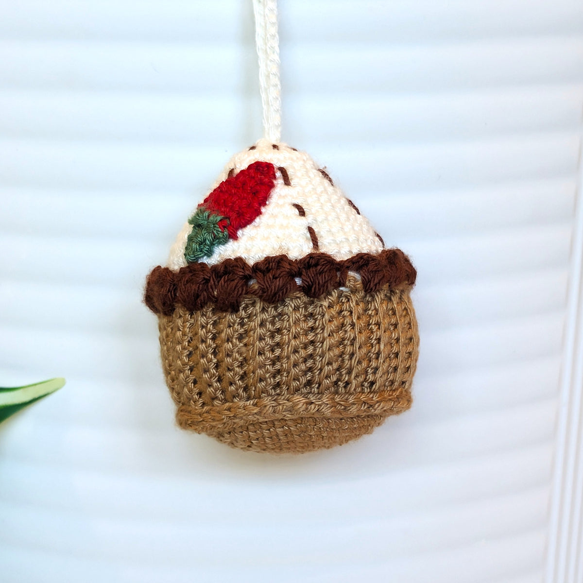 Strawberry topped handmade crochet cupcake keychain charm or an ornament.