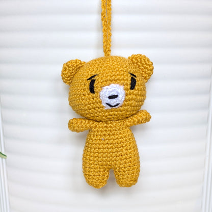 Marigold colored crocheted mini teddy bear bag charm with string