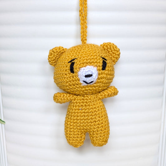 Marigold colored crocheted mini teddy bear bag charm with string