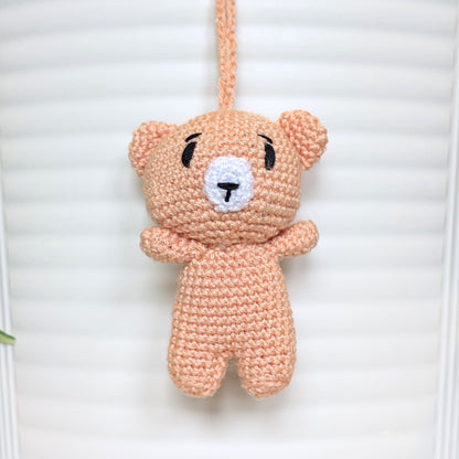 Peach colored crocheted mini teddy bear bag charm with string