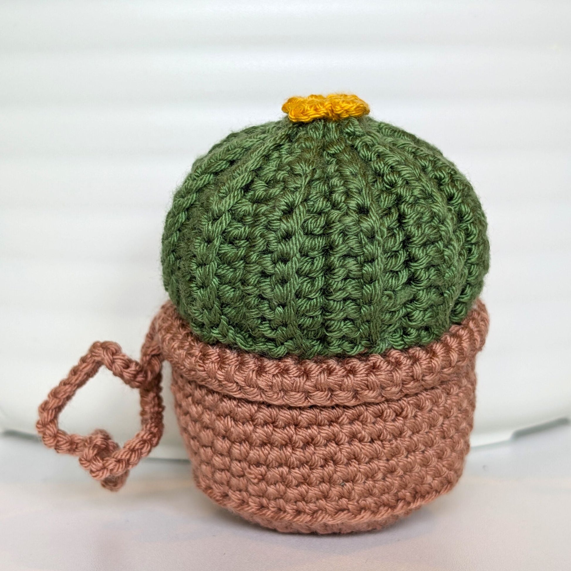 Crocheted moon cactus in a blush brown pot and with a string