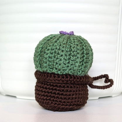Crocheted moon cactus charm with a lavender flower and attached string, potted in a brown pot