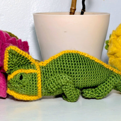 Crocheted plush chameleon in green and yellow colors