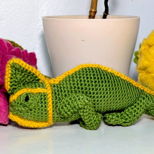 Crocheted plush chameleon in green and yellow colors