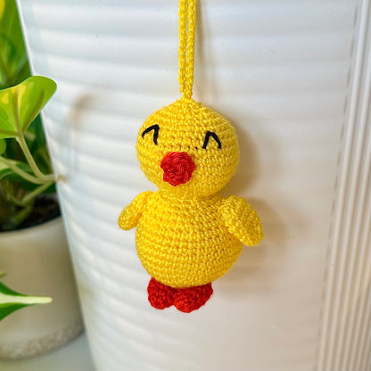 Crocheted yellow chick with a string