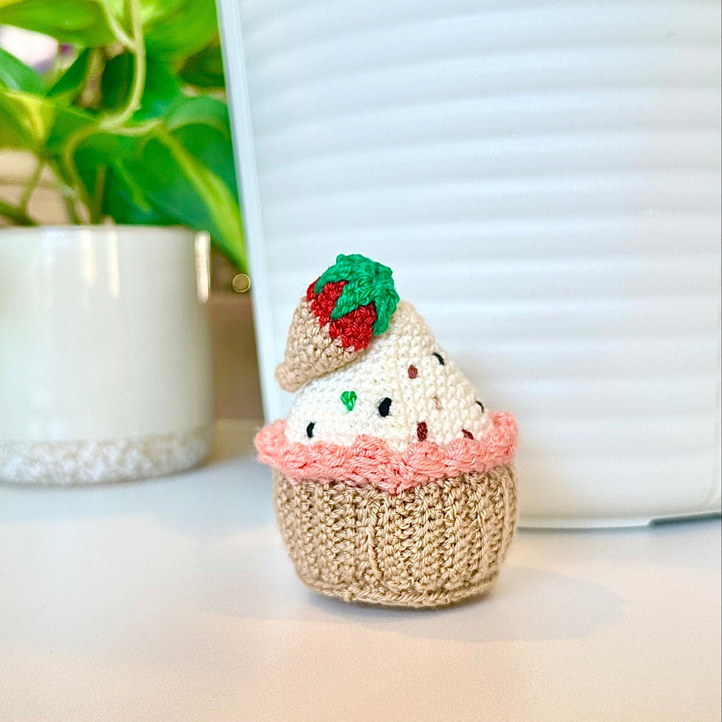 Crocheted chocolate covered strawberry cupcake keychain bag charm with a string 