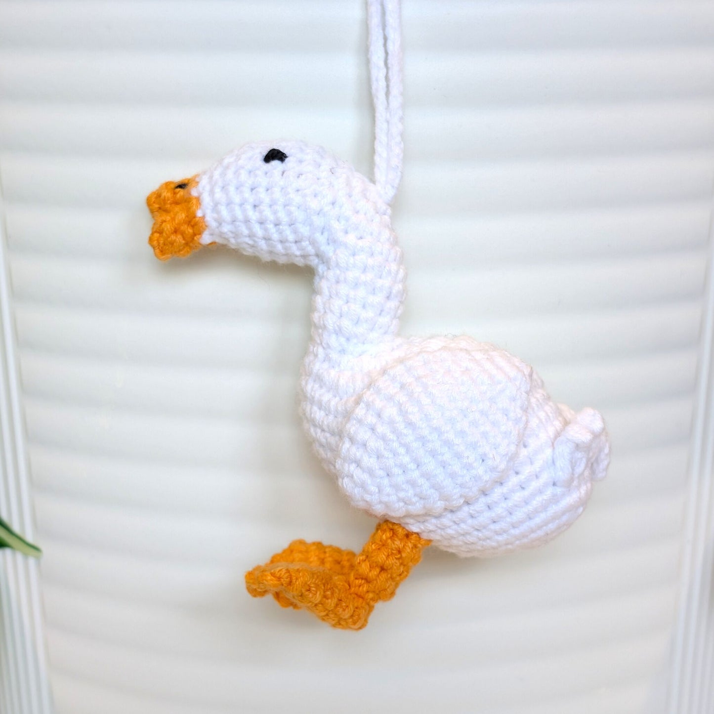 Crocheted duck keychain bag charm with orange beak and feet