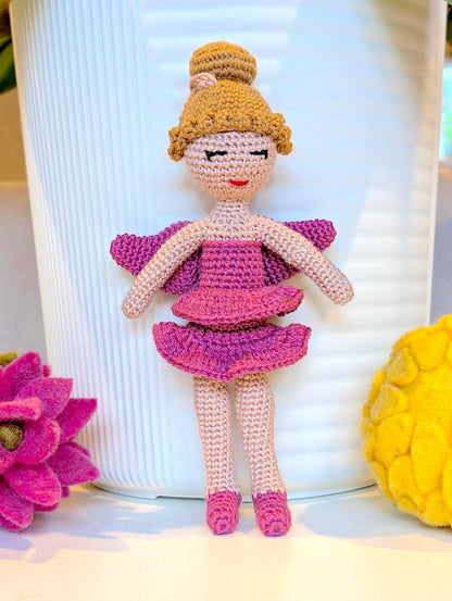 Crocheted plush ballerina fairy doll with pink outfit and golden blond hair in a bun