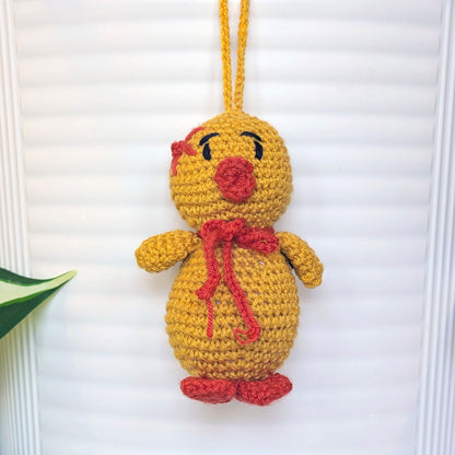 Crocheted golden yellow duck bag charm with string wearing star and scarf