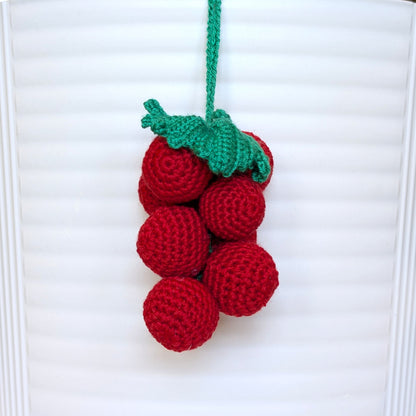 Crocheted red grapes with green stem and string
