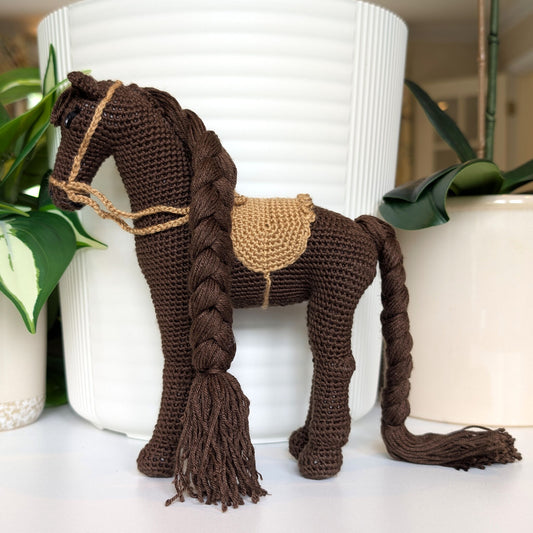 Crocheted horse plush with braided mane and tail with beige saddle