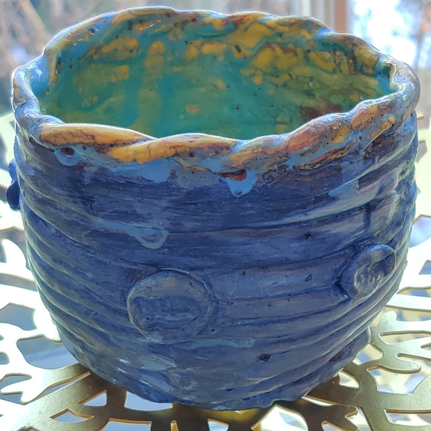Blue clay pot with textured surface