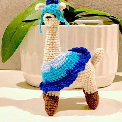 Crocheted llama figurines with blue attire and hat 