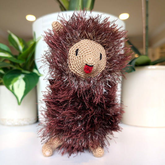 Crocheted fluffy Pomeranian dog with burgundy and silver coat sticking tongue out