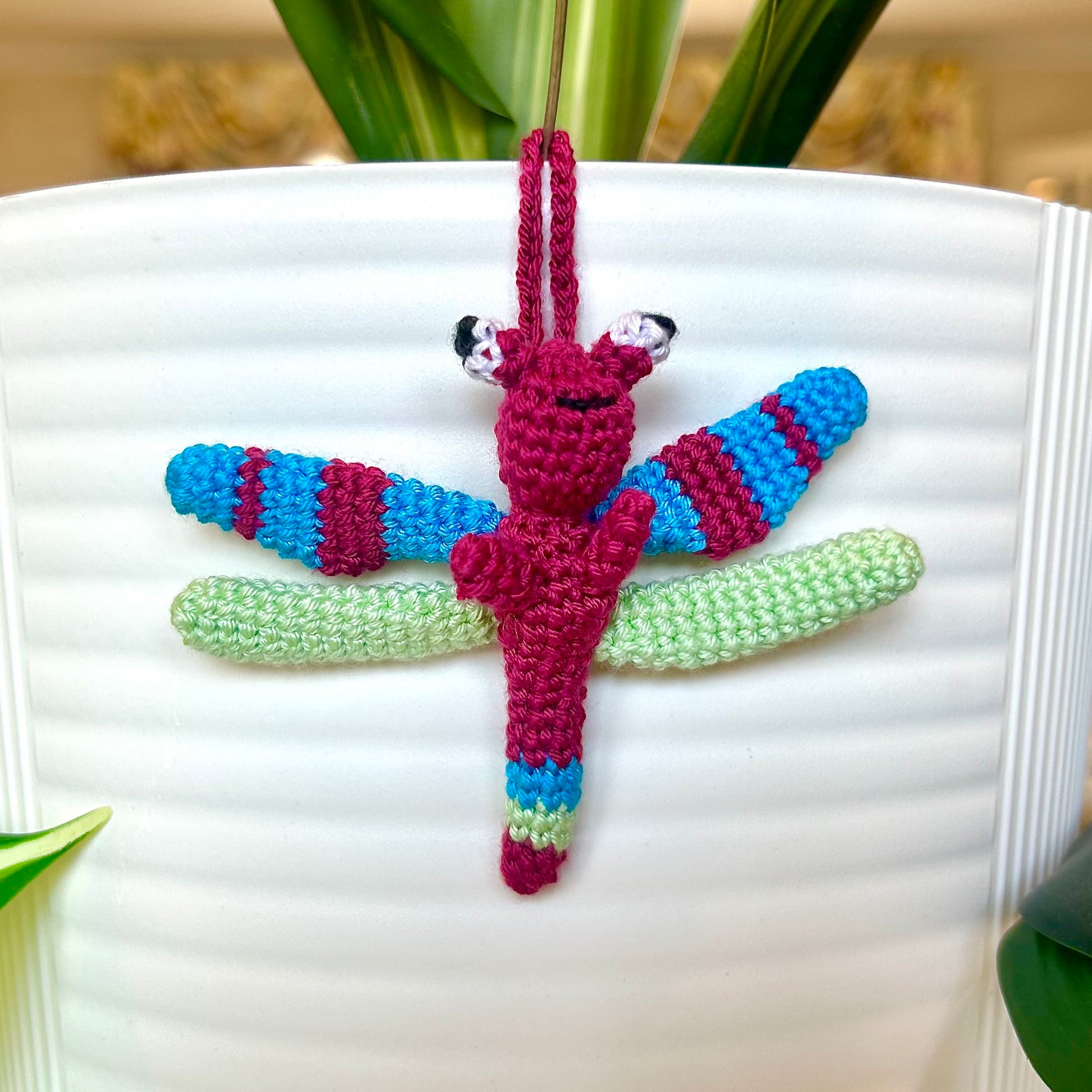 Mini crocheted dragonfly charm with berry, azure, and mint green stripes