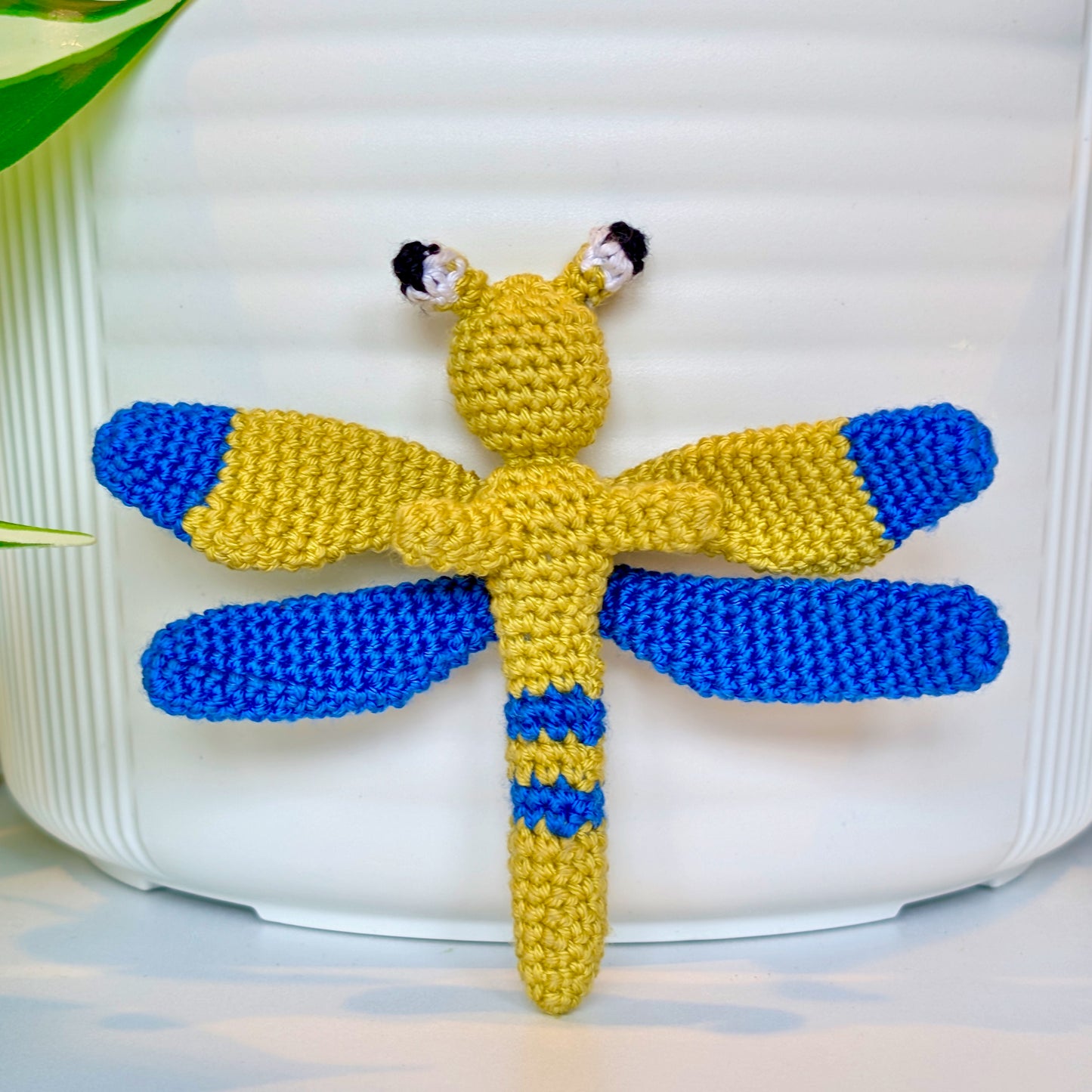 Small crocheted chartreuse and blue dragonfly figurine