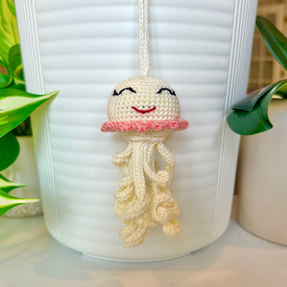 Crocheted cream jellyfish bag charm with coral trim