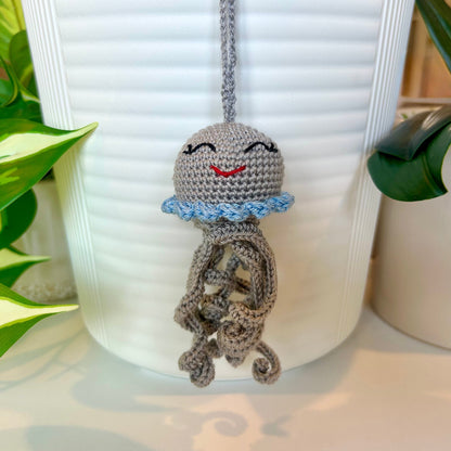 Crocheted gray jellyfish bag charm with light blue trim