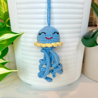 Crocheted light blue jellyfish bag charm with light yellow trim