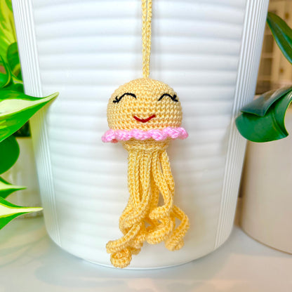 Crocheted light yellow jellyfish bag charm with pink trim