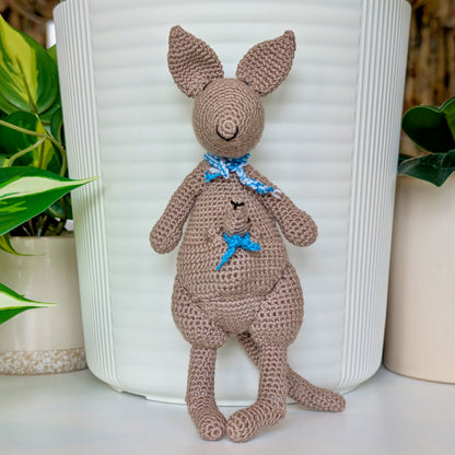 Crocheted kangaroo wearing an azure and white scarf with a baby joey in her pouch also wearing an azure scarf