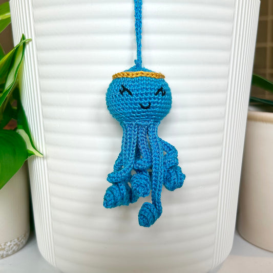 crocheted azure octopus charm with an amber halo