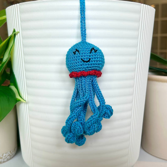 Crocheted azure octopus charm with red trim
