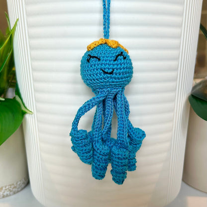Crocheted Octopus charm in Azure with a large amber flower on its head