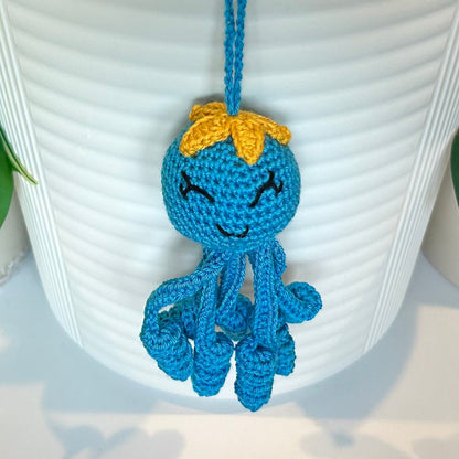 Crocheted Octopus charm in Azure with a large amber flower on its head
