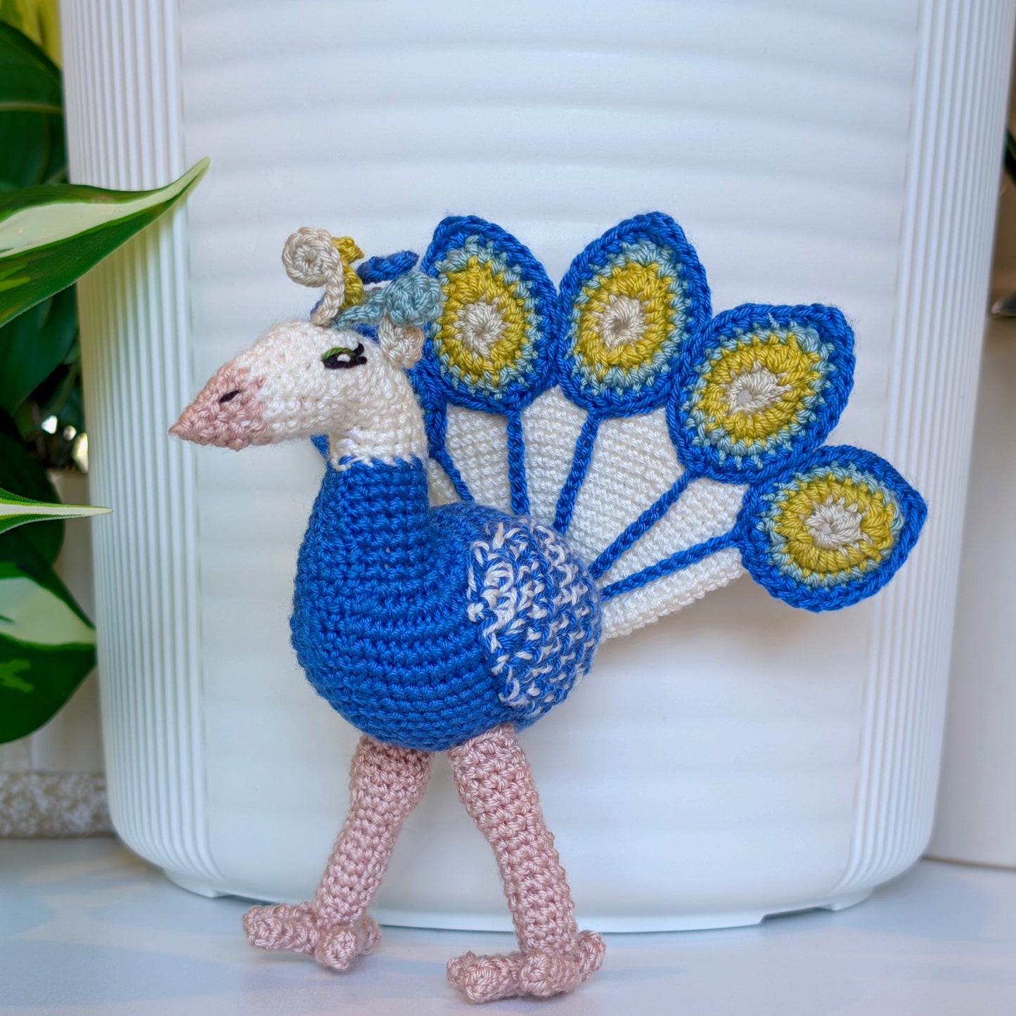 crocheted peacock in cobalt blue with white and chartreuse accents