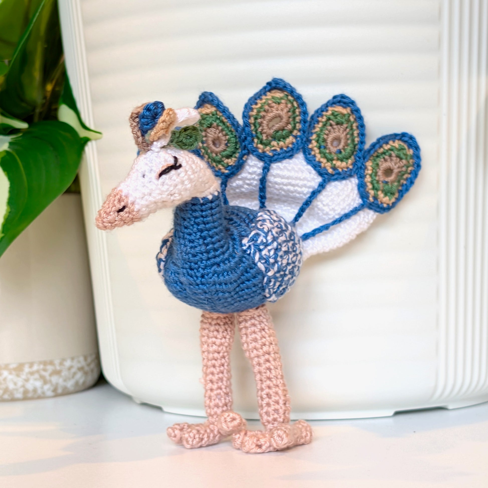 crocheted peacock in peacock blue with White, dark Sage, and Rich Taupe accents
