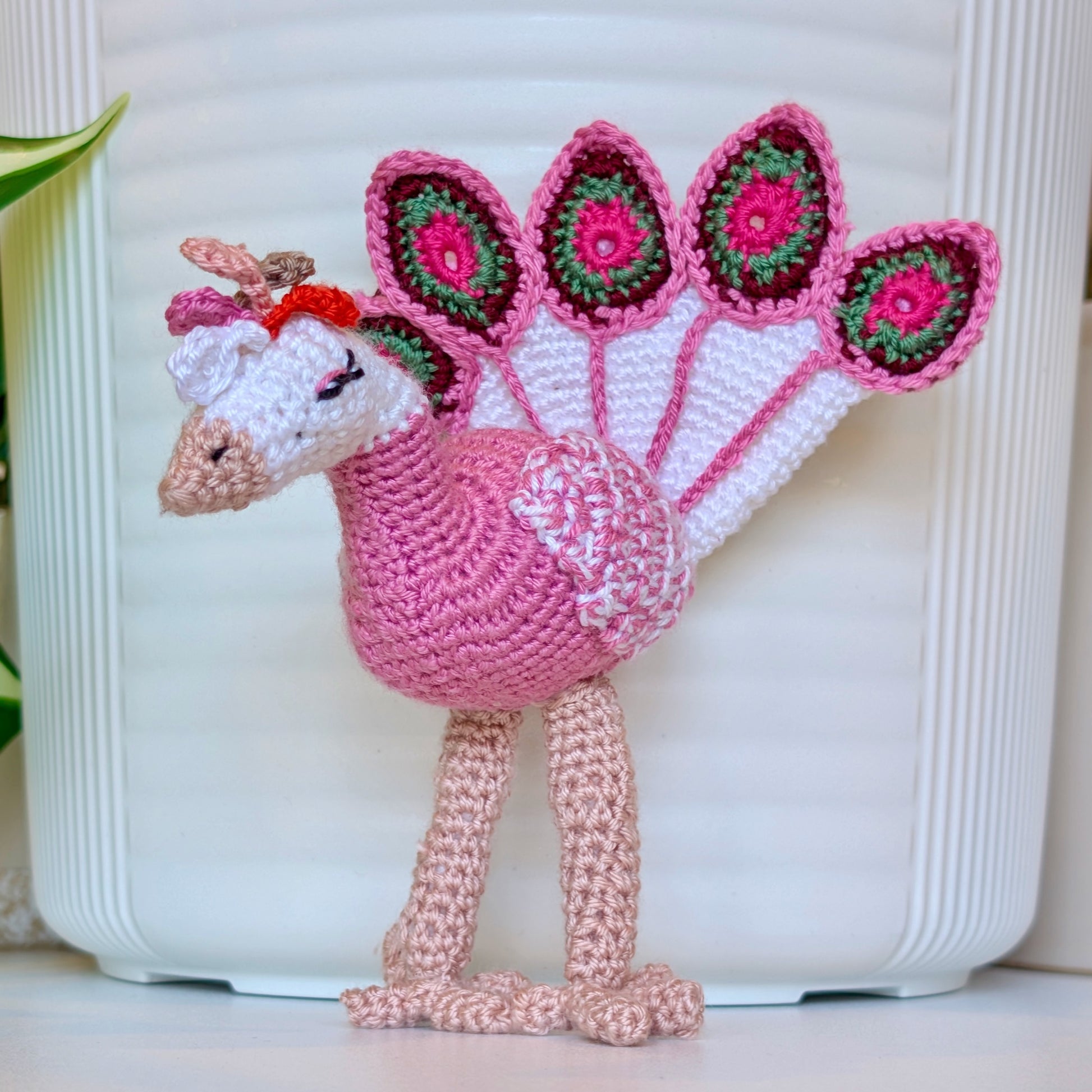 Crochet peacock in french pink with White, Burgundy, and Dark Sage Green accents