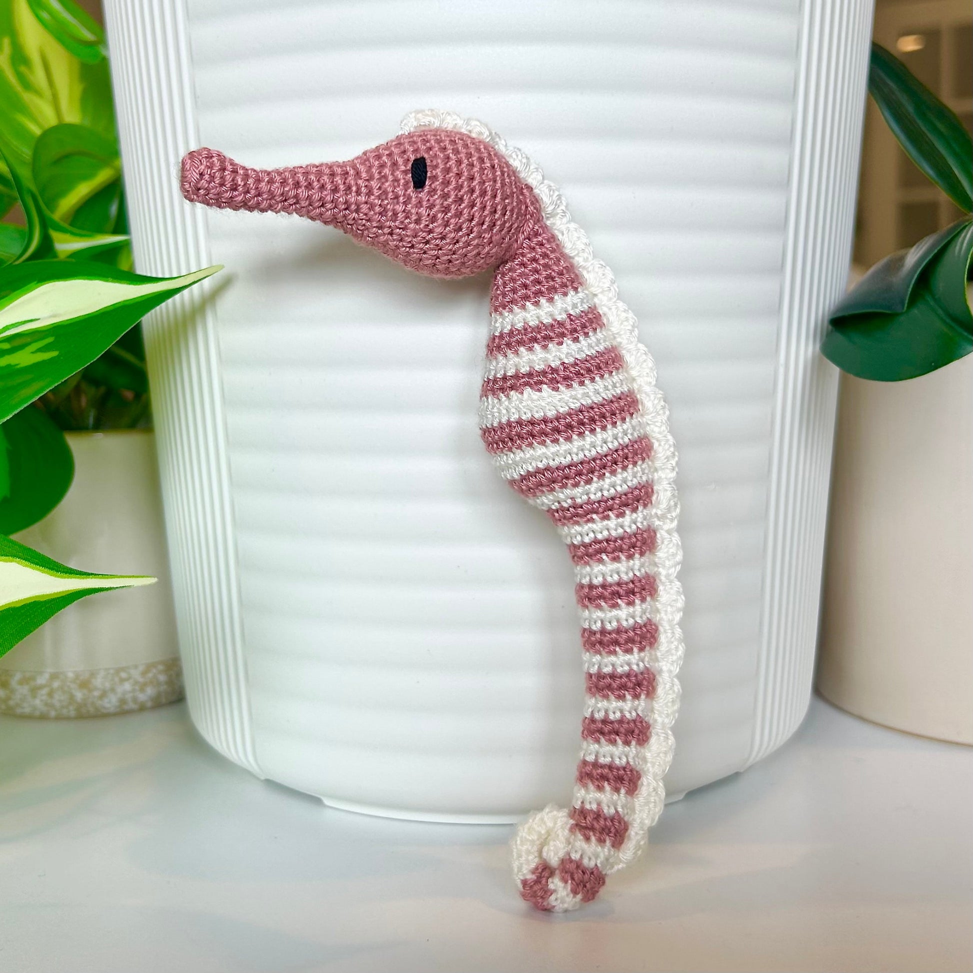 Crocheted dusty rose seahorse figurine with ivory stripes