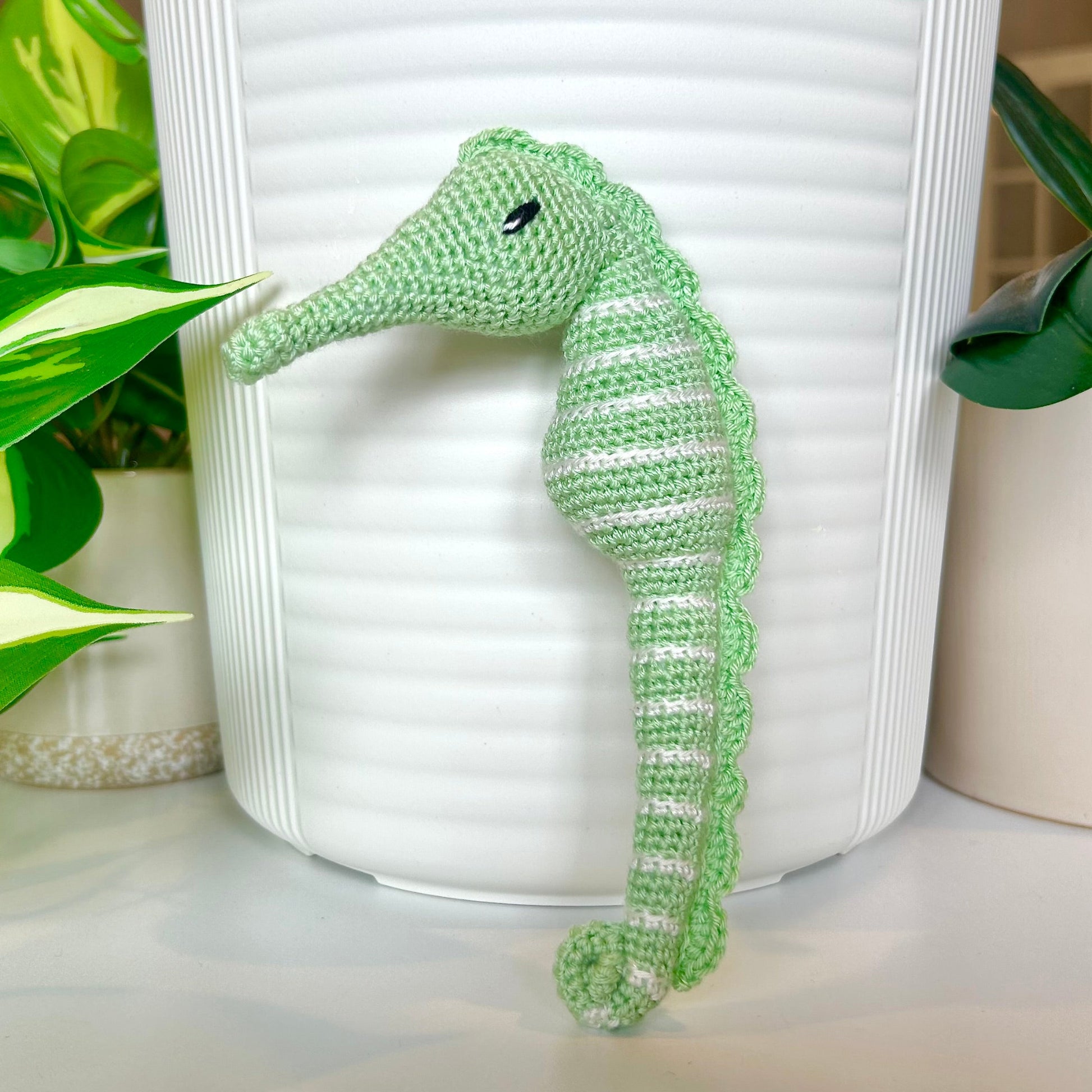 Crocheted light mint seahorse figurine with white stripes