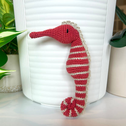 Crocheted red plum seahorse figurine with Limestone colored stripes
