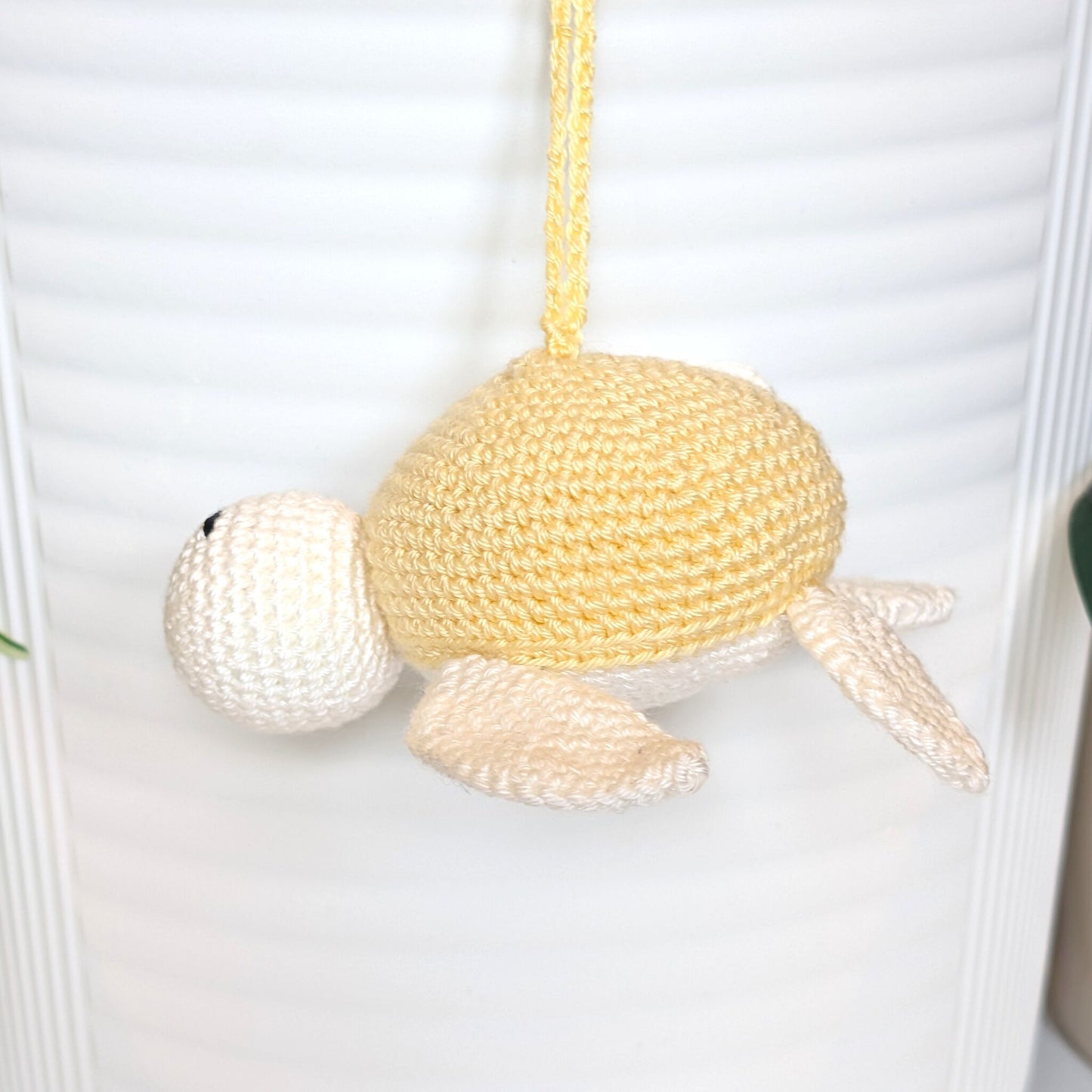 Crocheted sea turtle charm keychain with a dusty creme brulee colored shell