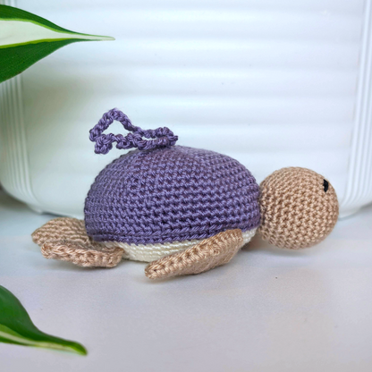 Crocheted Sea turtle with light amethyst/ purple shell with beige body and a string
