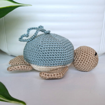 Crocheted Sea turtle with light seafoam blue shell with beige body and a string
