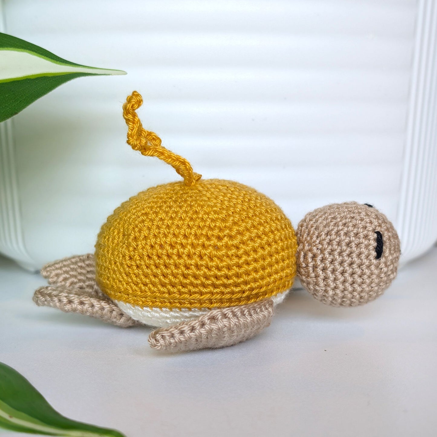 Crocheted Sea turtle with light sunflower yellow shell with beige body and a string
