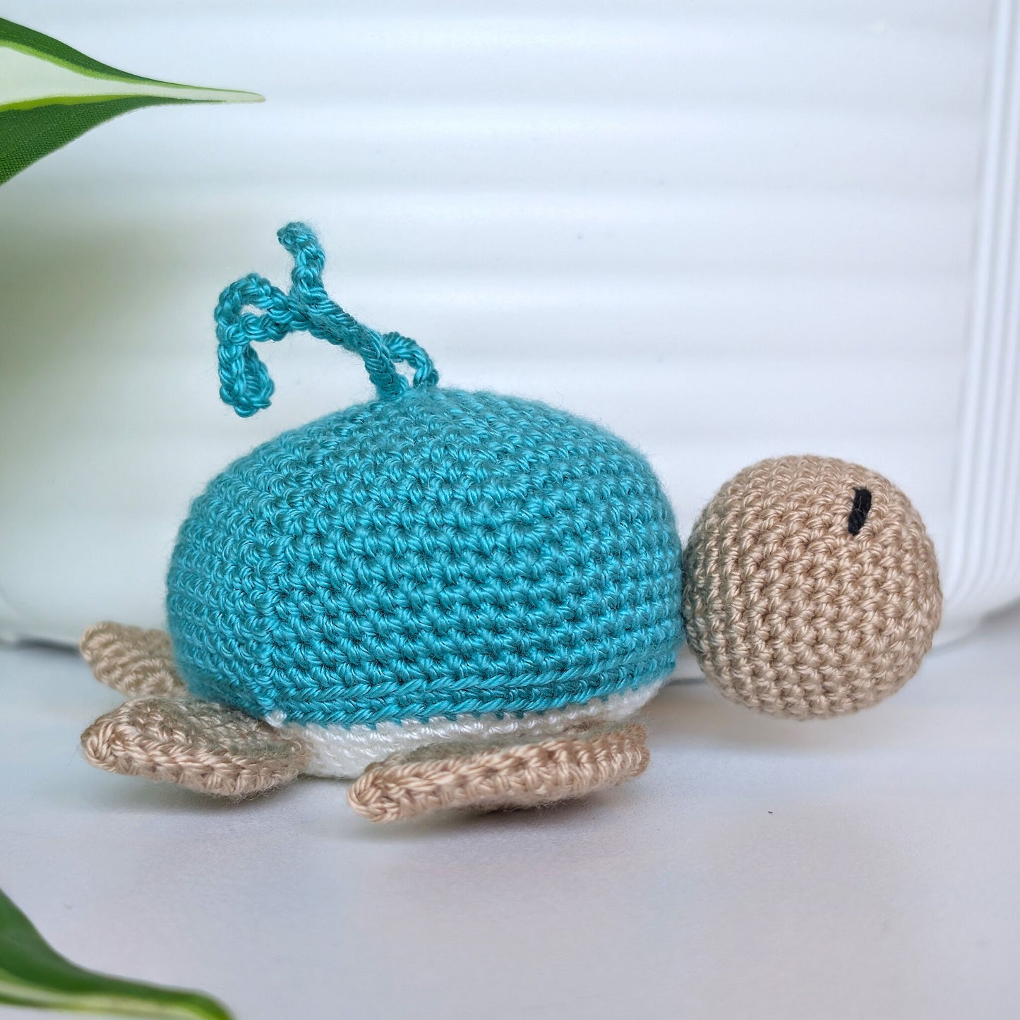 Crocheted Sea turtle with light turquoise shell with beige body and a string
