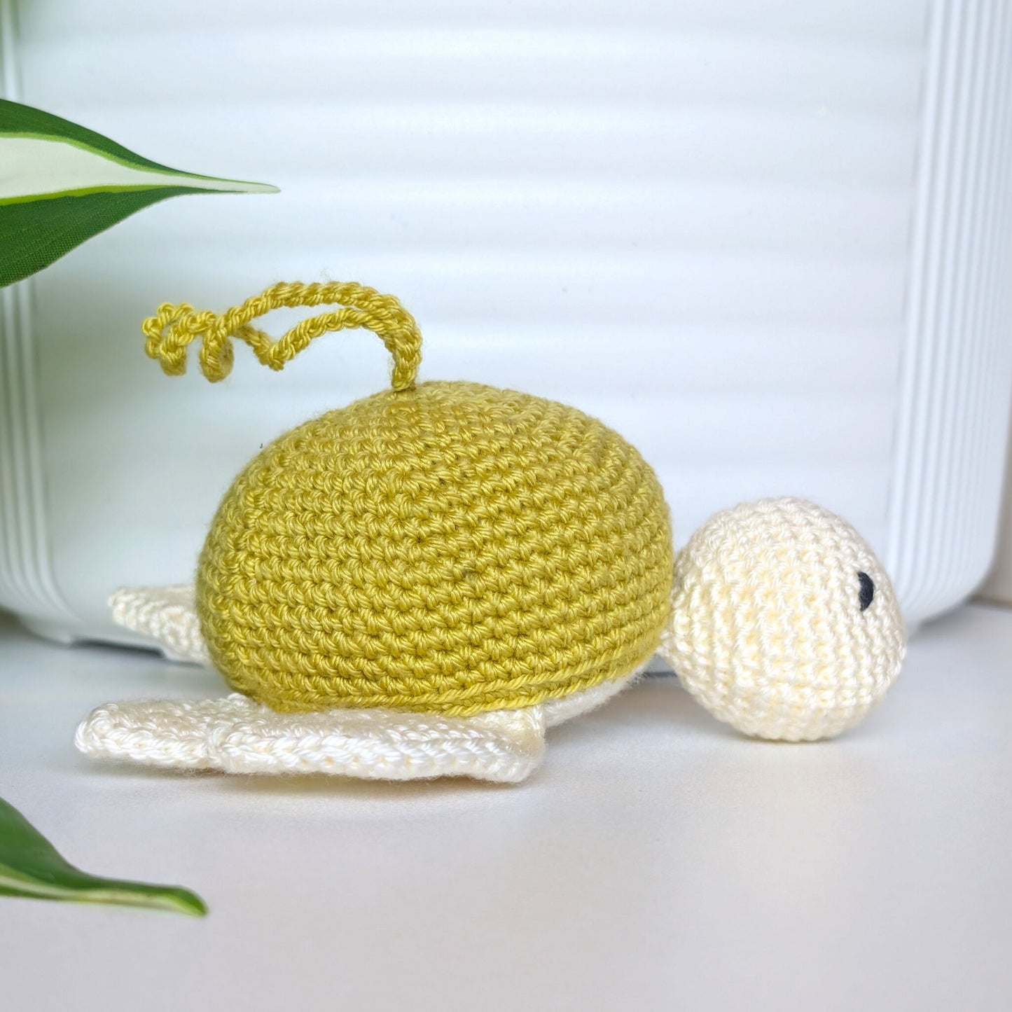 Crocheted sea turtle charm keychain with a chartreuse shell