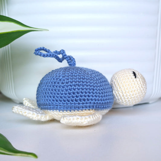 Crocheted sea turtle charm keychain with a cornflower blue shell