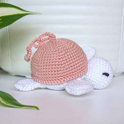 Crocheted sea turtle charm keychain with a dusty pink shell