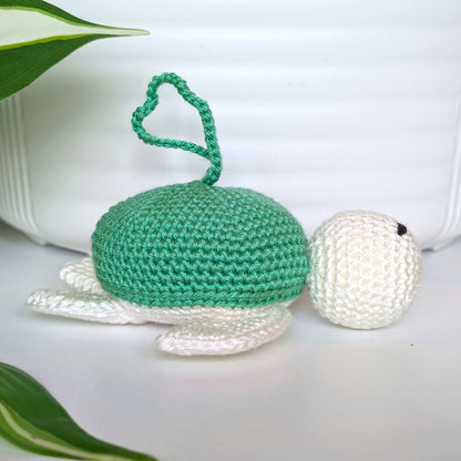 Crocheted sea turtle charm keychain with a jade green shell