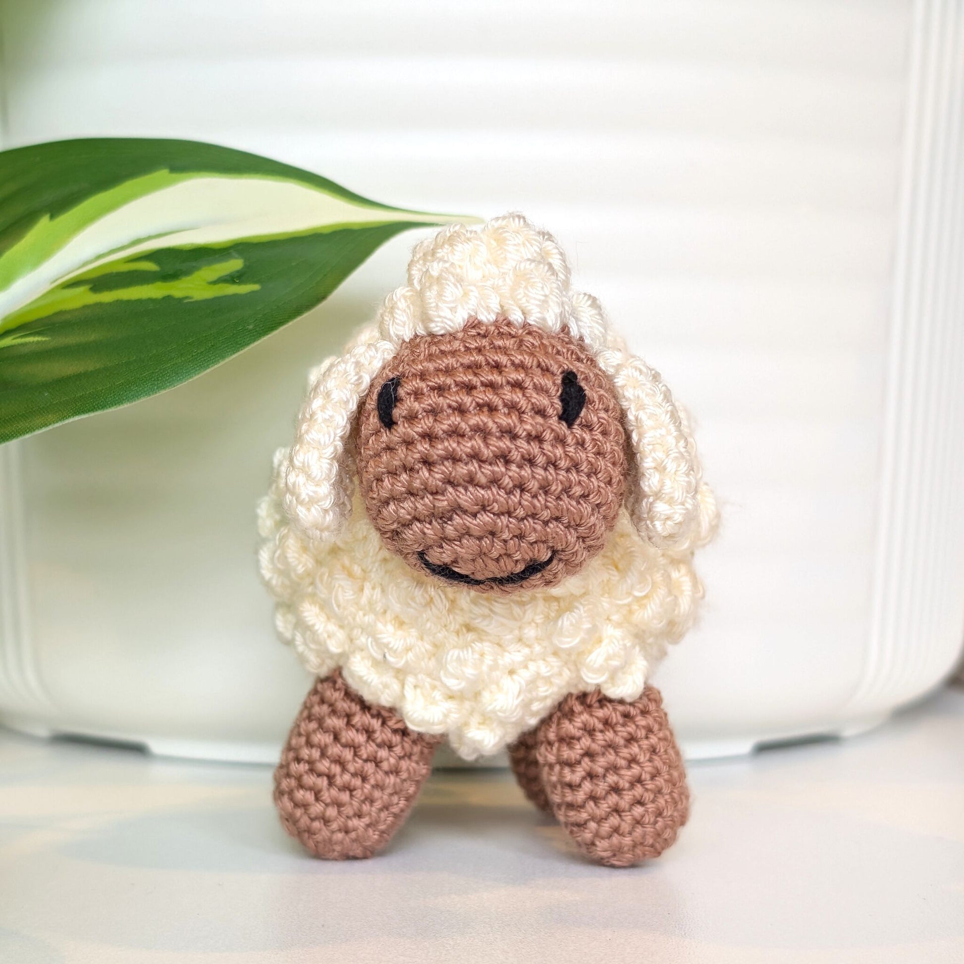 Front view of crocheted cream fleece sheep plush with oatmeal body
