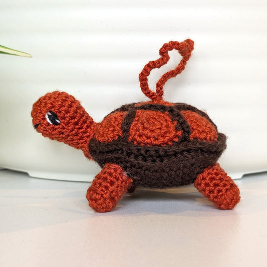 Crocheted turtle toy with terracotta shell and brown body